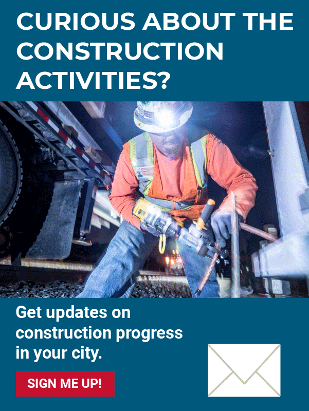 Man in construction equipment drilling a steel bar