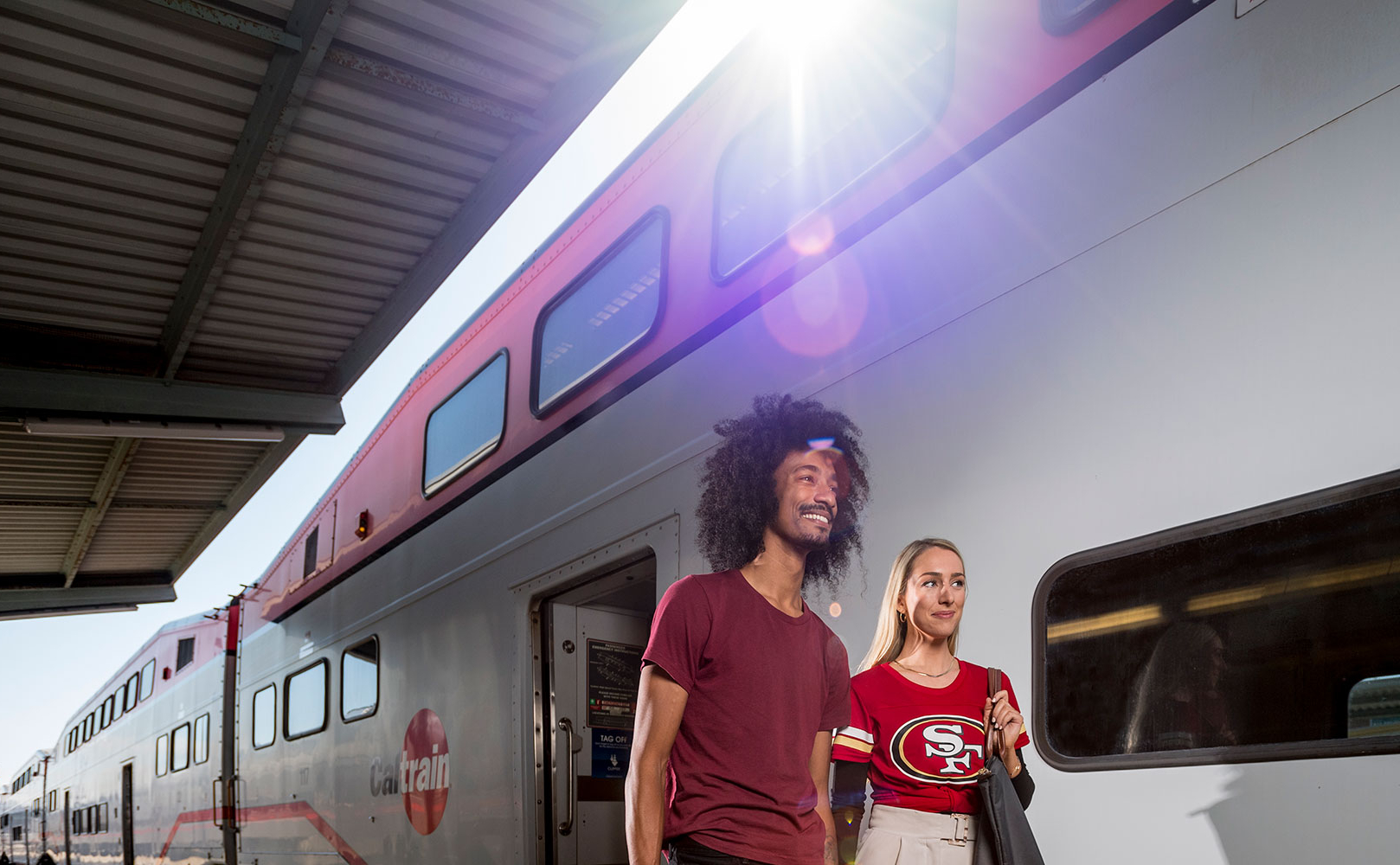 A couple of passengers getting off the train
