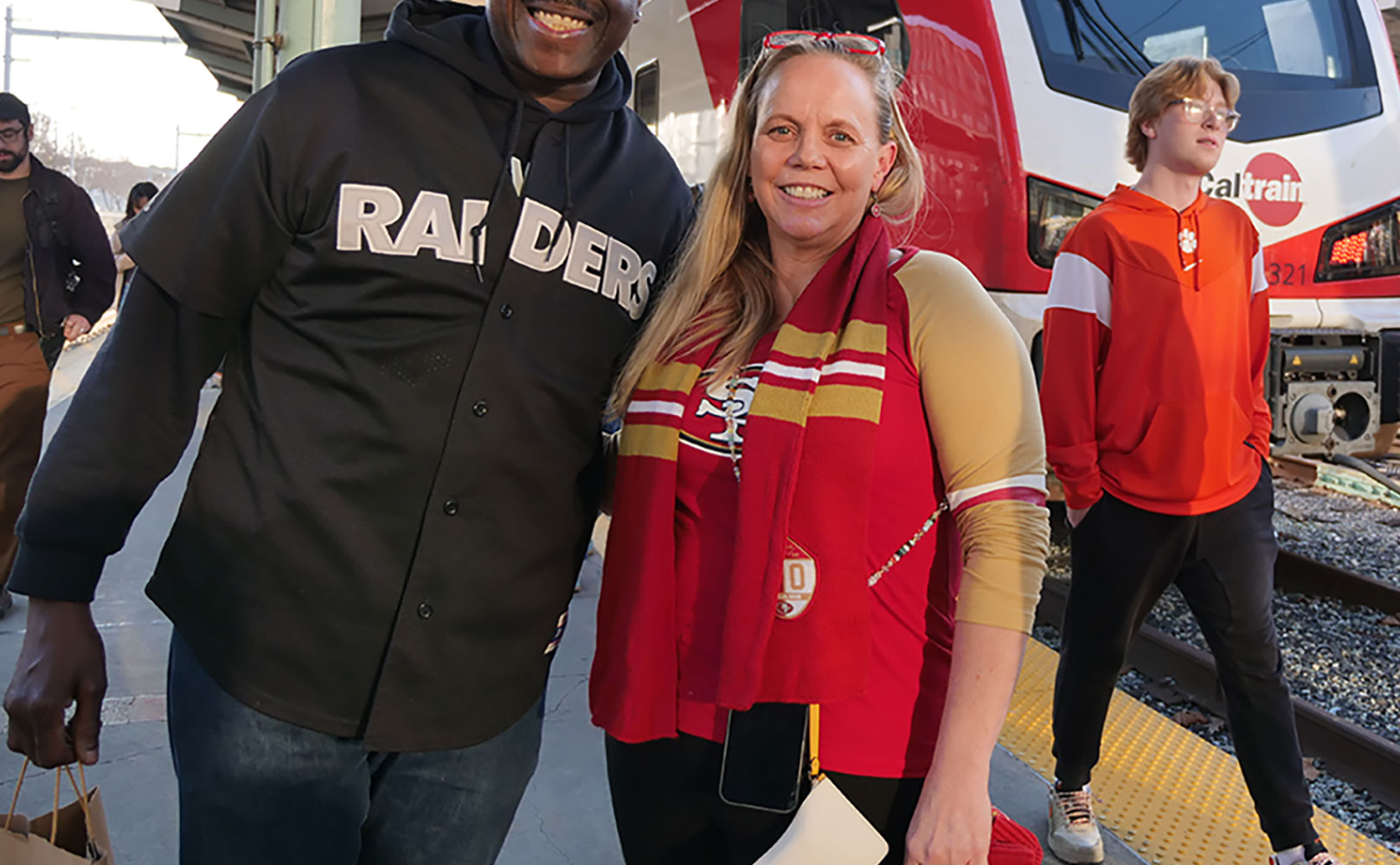 Sports fans posing at the train station