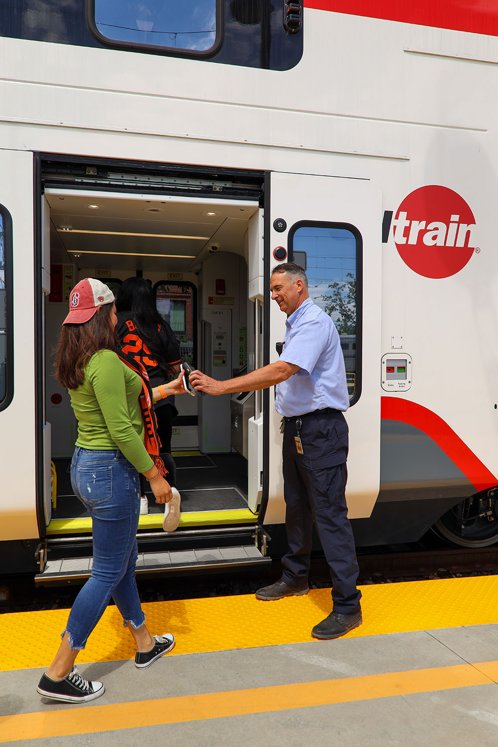 Train conductor scanning passengers mobile phone