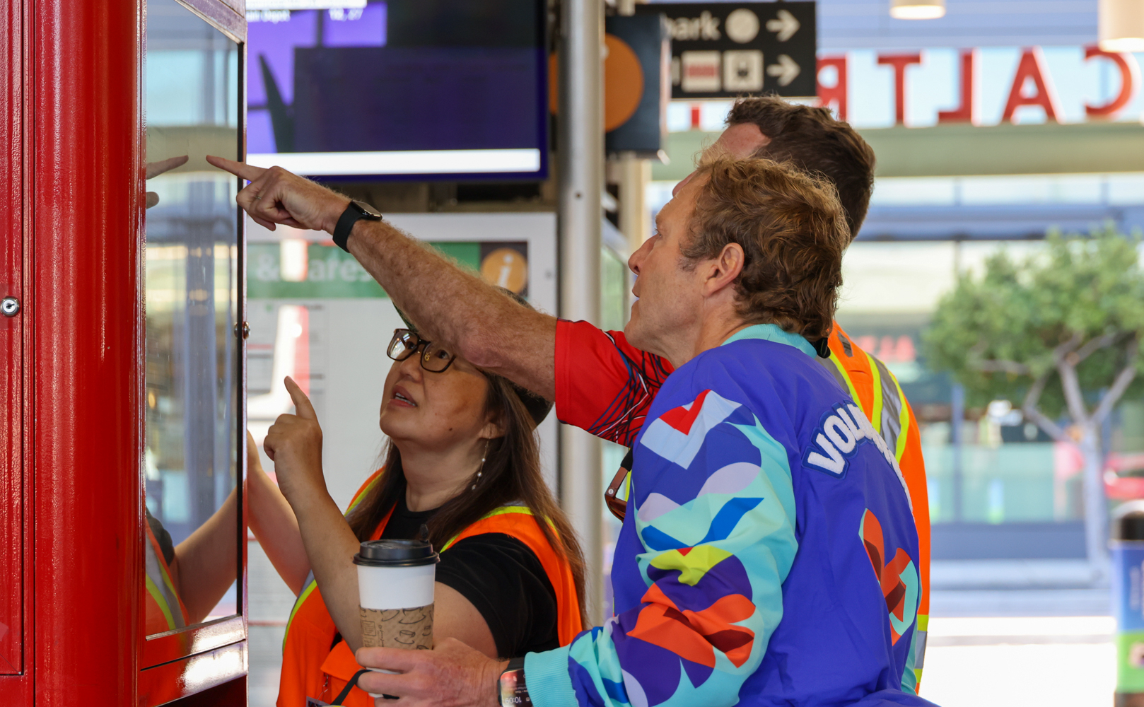 Caltrain staff help World Cup fan read the timetable