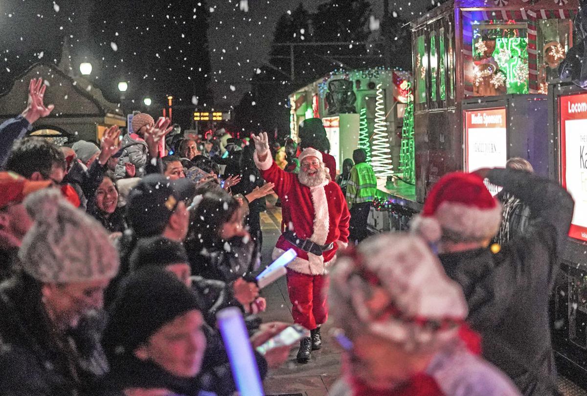 Santa waves at revelers in front of the Holiday Train