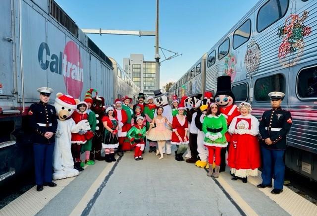 Holiday Train characters post in front of train