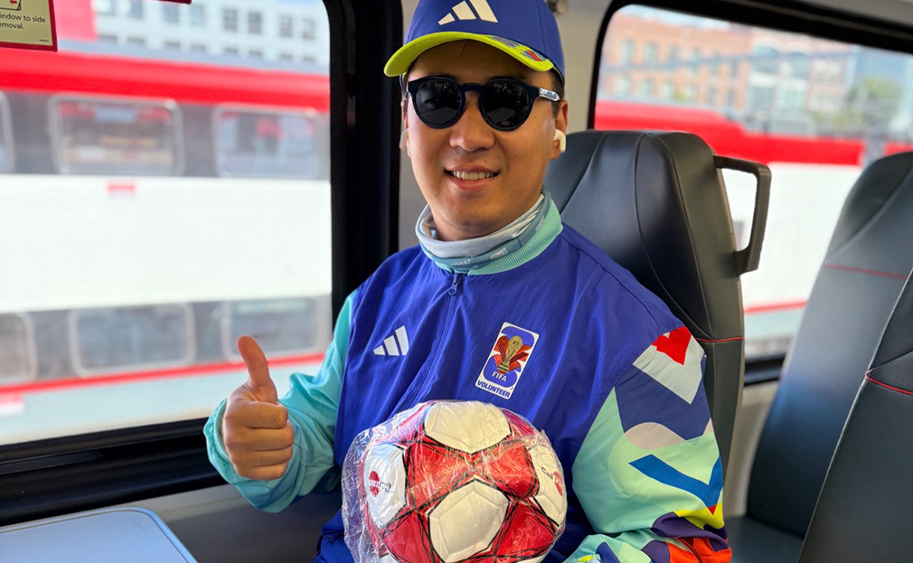 Soccer Fan holding Caltrain branded Soccer Ball