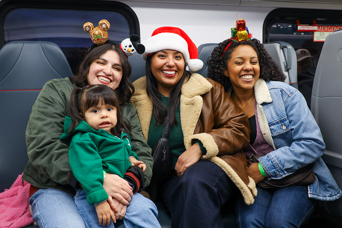 Group of people in festive gear posing train