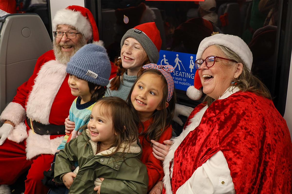 Kids pose with Santa and Mrs. Claus