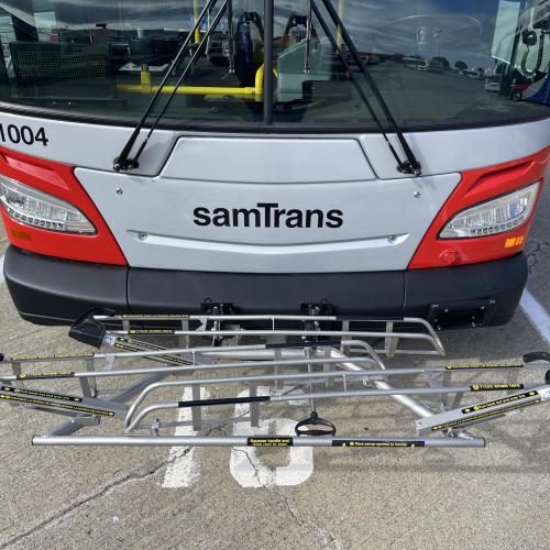 The front of a SamTrans bus with a new bike rack.