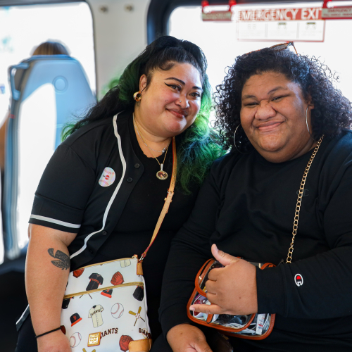 Two passengers posing in Caltrain EMU