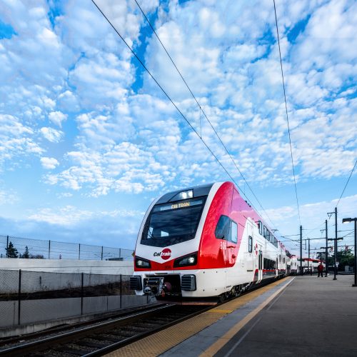 Caltrain train in front of a beautiful blue sky